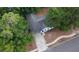 Aerial view shows the home situated on a wooded lot with a driveway and walkway at 901 Cascades Park Trl, Deland, FL 32720