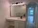 Modern bathroom vanity and mirror with views into the living room and stand-alone tub at 901 Cascades Park Trl, Deland, FL 32720