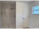 Modern bathroom with a walk-in shower featuring stylish marble tile and black fixtures at 901 Cascades Park Trl, Deland, FL 32720