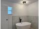 A sleek bathroom features a modern tub, black fixtures, and trendy marble tile at 901 Cascades Park Trl, Deland, FL 32720