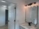 Bathroom vanity with a quartz countertop, undermount sink, and modern lighting fixture at 901 Cascades Park Trl, Deland, FL 32720