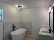 A sleek bathroom features a modern tub, black fixtures, and trendy marble tile at 901 Cascades Park Trl, Deland, FL 32720
