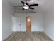 A bright, open bedroom features vaulted ceilings, a fan, and wood-look floors at 901 Cascades Park Trl, Deland, FL 32720