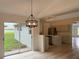 Dining Area with pendant lighting, sliding glass doors leading to the patio, and hardwood floors at 901 Cascades Park Trl, Deland, FL 32720