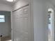 Hallway features bi-fold closet doors with access to a bathroom at 901 Cascades Park Trl, Deland, FL 32720