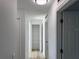 Bright hallway with new flooring leads to a spacious shelved storage room at 901 Cascades Park Trl, Deland, FL 32720