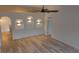 Bright living area with unique recessed lighting, modern fan, and light wood-look floors at 901 Cascades Park Trl, Deland, FL 32720