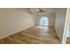 Open living room with vaulted ceilings, fan, wood-look floors, and a large arched window illuminating the space at 901 Cascades Park Trl, Deland, FL 32720