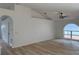 Bright living room with stylish arch window, vaulted ceiling, and wood-look flooring at 901 Cascades Park Trl, Deland, FL 32720