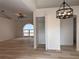 A modern light fixture hangs in the entryway off the living room, which has vaulted ceilings and an arched window at 901 Cascades Park Trl, Deland, FL 32720