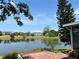 Picturesque lake view from the brick paved patio with mature trees and lush landscaping at 904 W Charing Cross Cir, Lake Mary, FL 32746