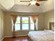 Serene bedroom featuring natural light and a calming lake view at 904 W Charing Cross Cir, Lake Mary, FL 32746