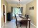 Well-lit dining room features wood table with seating for six and decorative curtains at 904 W Charing Cross Cir, Lake Mary, FL 32746