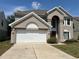 Charming two-story stucco home with a two-car garage and well-maintained landscaping at 904 W Charing Cross Cir, Lake Mary, FL 32746