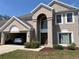 Charming two-story stucco home with a two-car garage; car parked inside at 904 W Charing Cross Cir, Lake Mary, FL 32746