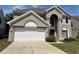 Charming two-story stucco home with a two-car garage and well-maintained landscaping at 904 W Charing Cross Cir, Lake Mary, FL 32746