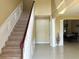 Bright foyer with a carpeted staircase, tile floors, and elegant architectural details at 904 W Charing Cross Cir, Lake Mary, FL 32746
