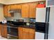 Kitchen features stainless steel appliances, black granite countertops, and white refrigerator at 904 W Charing Cross Cir, Lake Mary, FL 32746