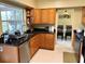 Eat-in kitchen boasts stainless steel appliances, wooden cabinetry and granite countertops at 904 W Charing Cross Cir, Lake Mary, FL 32746