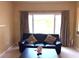 Inviting living room featuring a comfortable sofa and large window view at 904 W Charing Cross Cir, Lake Mary, FL 32746