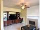 Spacious living room with tile flooring, fireplace, ceiling fan and built-in entertainment center at 904 W Charing Cross Cir, Lake Mary, FL 32746