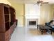 Open living room featuring a tile fireplace and built in entertainment center at 904 W Charing Cross Cir, Lake Mary, FL 32746