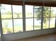 Bright sunroom features large windows with scenic lake views bringing the outdoors in at 904 W Charing Cross Cir, Lake Mary, FL 32746