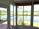 Bright sunroom with expansive windows offering serene lake views and a peaceful atmosphere at 904 W Charing Cross Cir, Lake Mary, FL 32746