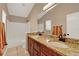 Bathroom features a granite countertop, double vanity, and bathtub with shower at 9668 Hollyhill Dr, Orlando, FL 32824