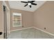 Neutral bedroom features tile floors, ceiling fan, and a closet with sliding doors at 9668 Hollyhill Dr, Orlando, FL 32824