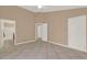 Spacious neutral bedroom features tile floors, multiple doors, and vaulted ceilings at 9668 Hollyhill Dr, Orlando, FL 32824