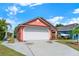 Charming single Gathering home with a well maintained lawn, attractive landscape and a two car garage at 9668 Hollyhill Dr, Orlando, FL 32824