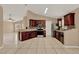 Spacious kitchen with tile floors, dark wood cabinets, stainless steel appliances, and vaulted ceilings at 9668 Hollyhill Dr, Orlando, FL 32824