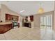 Bright kitchen with tile floors, dark wood cabinets, stainless steel appliances and an open floor plan at 9668 Hollyhill Dr, Orlando, FL 32824