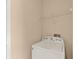 Laundry room features a white washer and a wire shelf at 9668 Hollyhill Dr, Orlando, FL 32824