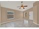 Bright living room featuring tile floors, vaulted ceiling, a ceiling fan and a front door at 9668 Hollyhill Dr, Orlando, FL 32824