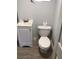 This is a simple bathroom with new flooring, blue paint, a sink and a toilet at 1010 Dakota Ave, St Cloud, FL 34769