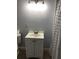 Bathroom vanity features a white cabinet, faucet, and a bright vanity light at 1010 Dakota Ave, St Cloud, FL 34769