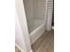 Clean white shower and new flooring complete this simple bathroom at 1010 Dakota Ave, St Cloud, FL 34769