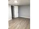 Bright bedroom featuring new light gray paint, light-colored flooring and a white door with chrome hardware at 1010 Dakota Ave, St Cloud, FL 34769