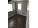 Bedroom with a window, back door and gray walls with luxury vinyl flooring at 1010 Dakota Ave, St Cloud, FL 34769