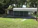 Exterior view of a gray home with a carport offering covered parking at 1010 Dakota Ave, St Cloud, FL 34769