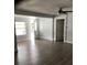 Living room with luxury vinyl flooring, ceiling fan and views into the yard at 1010 Dakota Ave, St Cloud, FL 34769