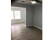 Living room with luxury vinyl flooring, a ceiling fan and a view of the yard at 1010 Dakota Ave, St Cloud, FL 34769