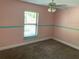 Bare bedroom featuring pink walls, a white ceiling fan and beige carpet at 1011 Chance Cv, Oviedo, FL 32765