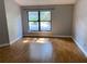 A serene empty room with a window offering natural light and warm wood-look flooring for a comfortable and airy feel at 1011 Chance Cv, Oviedo, FL 32765