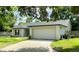 Charming single-story home featuring an attached two-car garage and a well-maintained front lawn with mature trees at 1011 Chance Cv, Oviedo, FL 32765