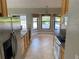 Well-lit kitchen with tile floors, light wood cabinets, and stainless steel refrigerator at 1011 Chance Cv, Oviedo, FL 32765