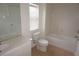 Well lit bathroom with tiled floors features a full bathtub and white cabinetry at 1034 Enclair St, Orlando, FL 32828