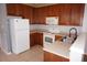 Functional kitchen with white appliances, tile floors, ample cabinetry, and a stainless steel sink at 1034 Enclair St, Orlando, FL 32828